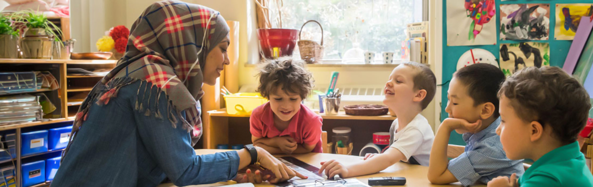 Teacher and young students in a classroom