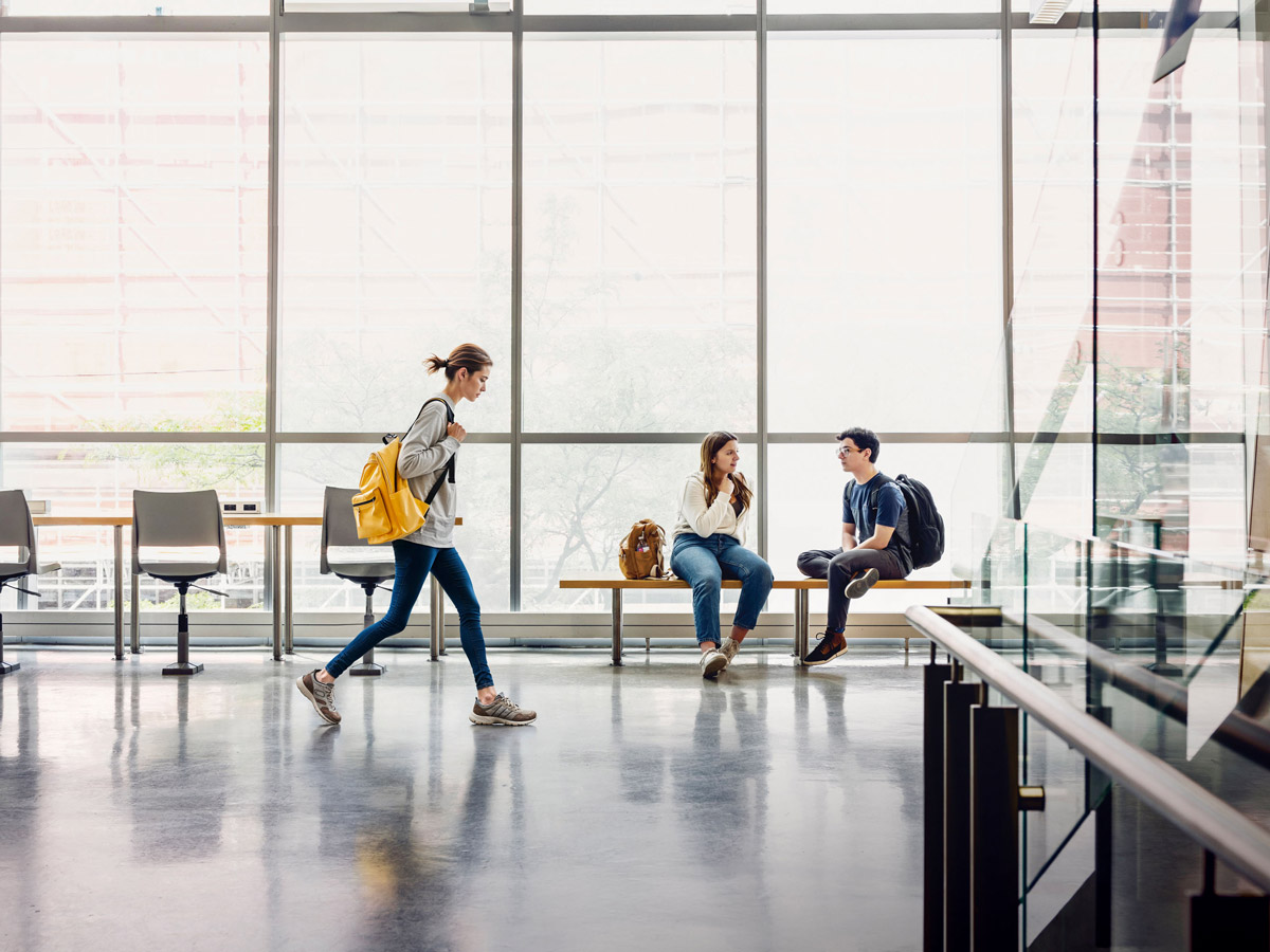 Students chat by the bright windows of TMU's George Vari Engineering and Computing Centre.