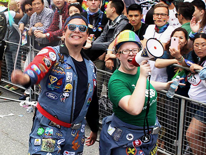 Two students from the student group EngOut march in the Pride parade