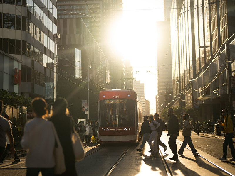 Pedestrians cross a street in downtown Toronto.