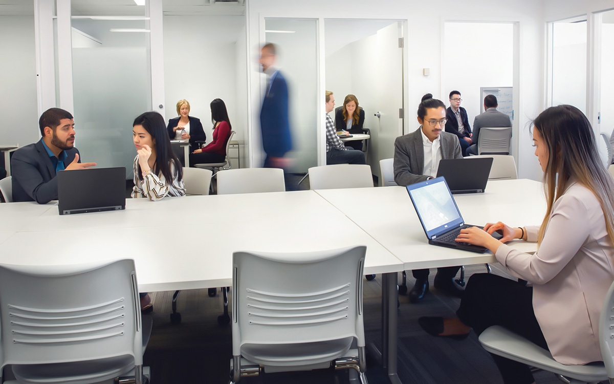Students work on projects around a table at the Ted Rogers School of Management.
