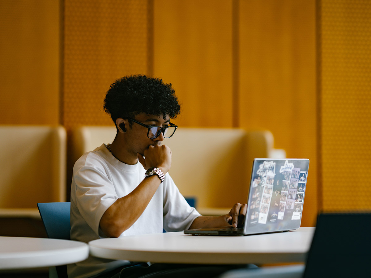 TMU students uses laptop in Daphne Coxwell Complex residence building