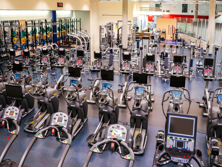A view of the MAC Fitness Center populated with cardio equipment amongst others.