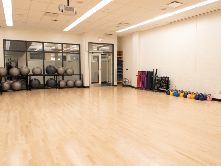 Studio X with wood floors and small equipment organized along the walls.