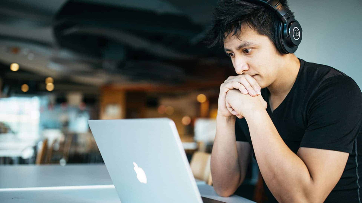 Student at a desk in front of a laptop