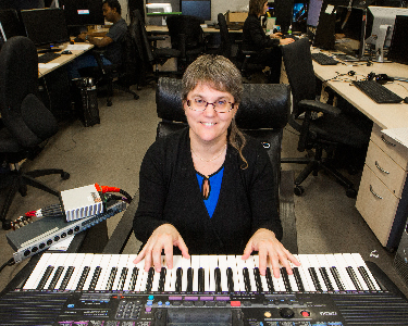 Information Technology Management Researcher, Deborah Fels, plays a keyboard.