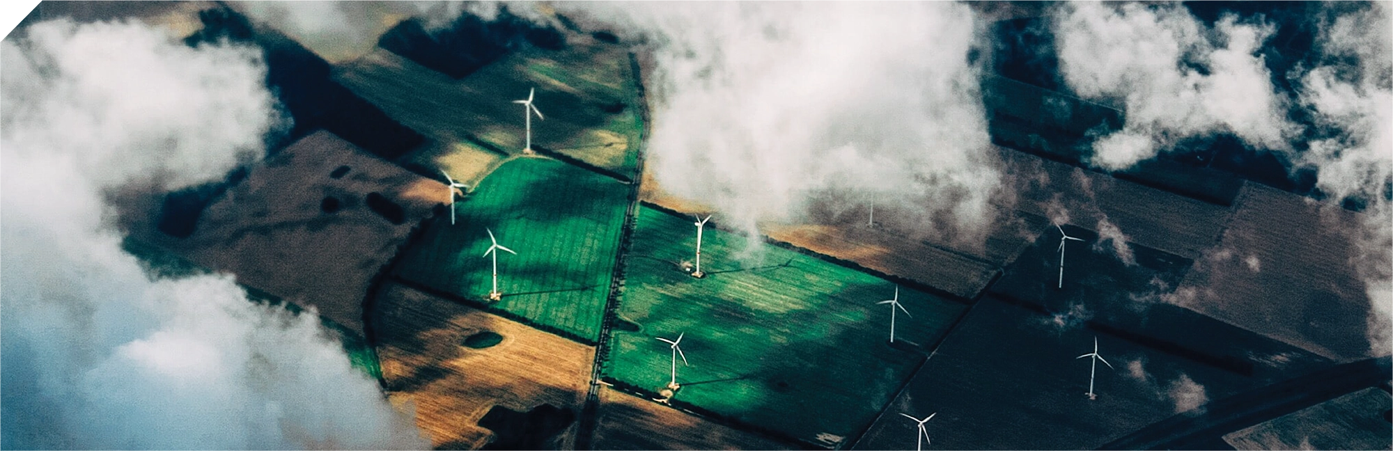 Aerial view of windmills on agricultural farmland.