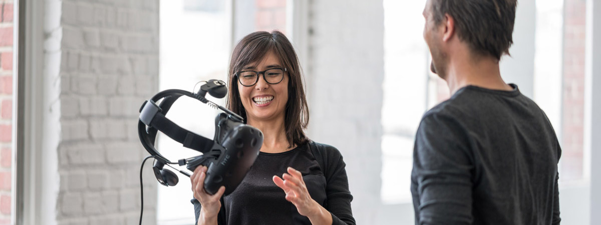 A woman reacts to experiencing virtual reality for the first time.