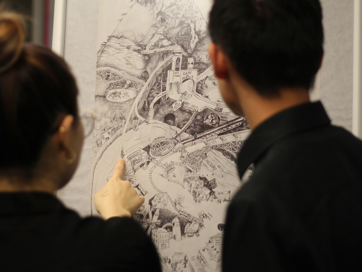 Two individuals looking at a drawing in a gallery