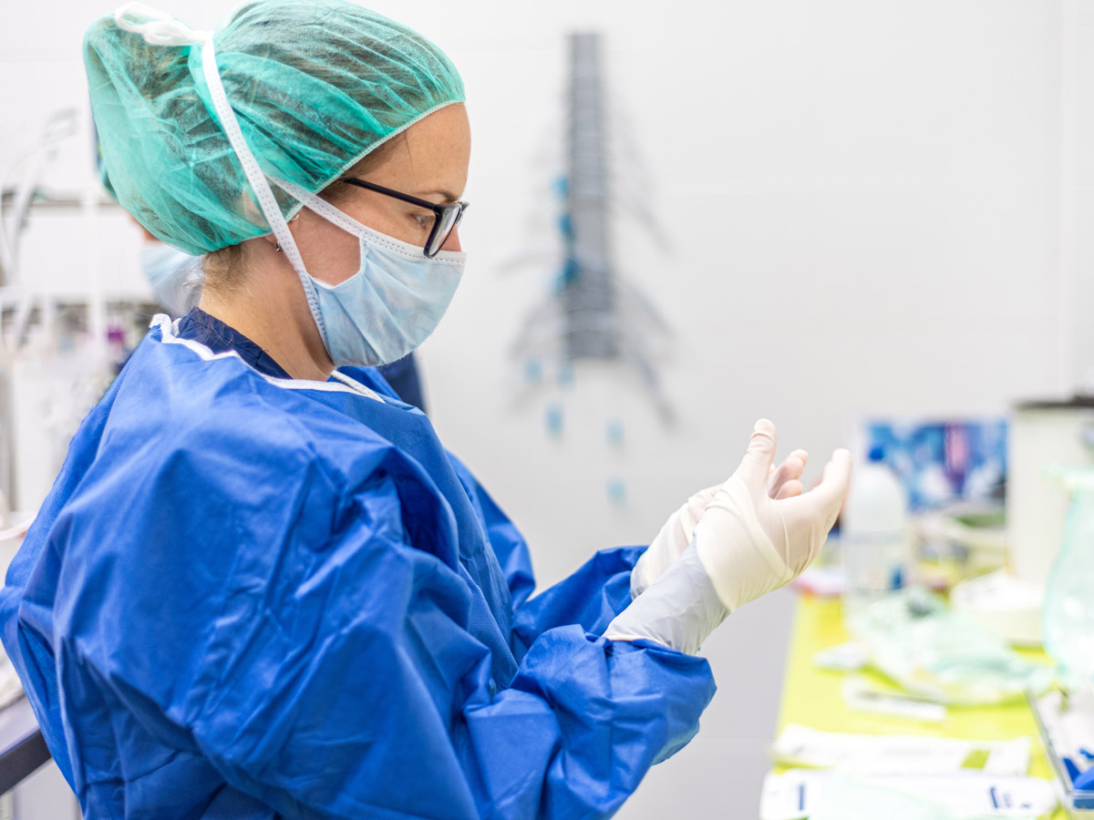 A nurse wearing a face mask and protective clothing