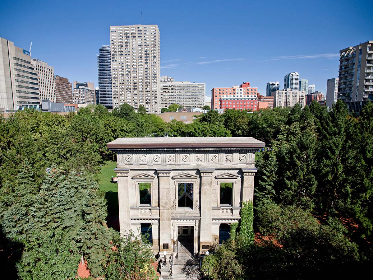 A stone facade stands amongst the trees in Ryerson’s Kerr Hall quad.