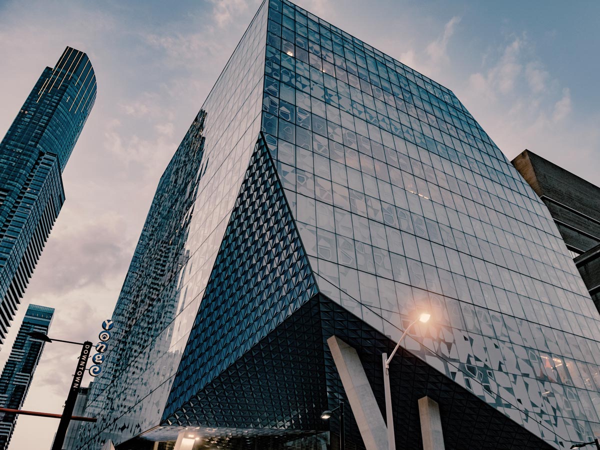 The blue glass of the Student Learning Centre reflects the light and sky. 