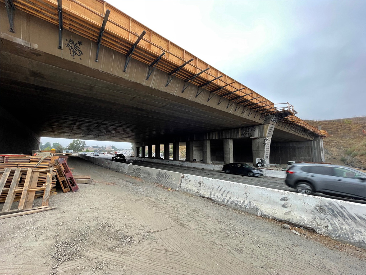A view of the Wallis Annenberg Wildlife Crossing in Los Angeles, California, from the highway below, with cars driving underneath