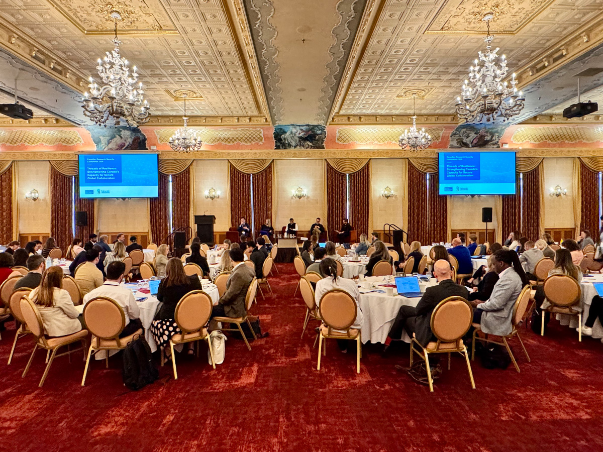 Wide view of the 2026 Canadian Research Security Conference, with attendees seated at round tables in an ornate ballroom listening to a panel discussion