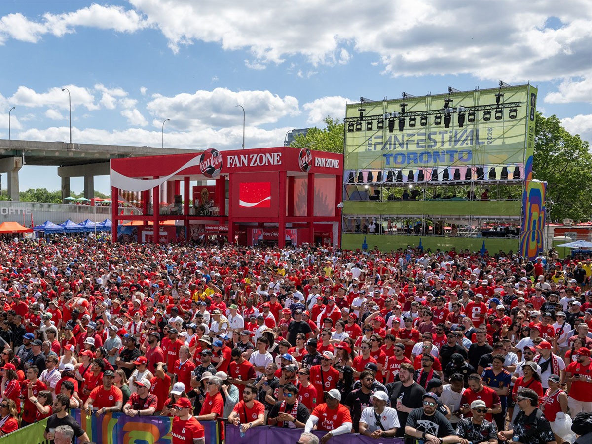 A large group of soccer fans stand outside to watch a game on the big screen at the FIFA Fan Festival™ site in Toronto. 