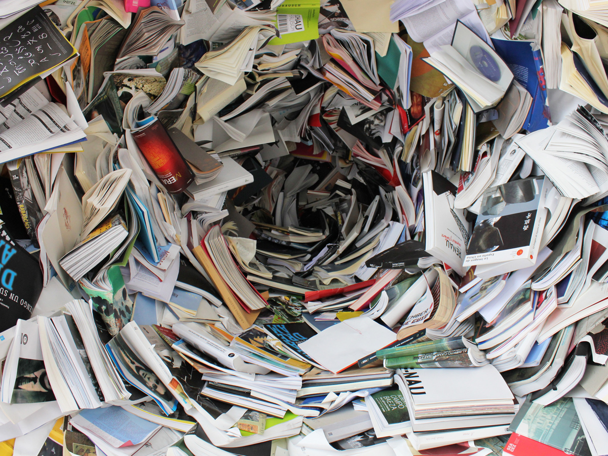 A large pile of battered books and magazines