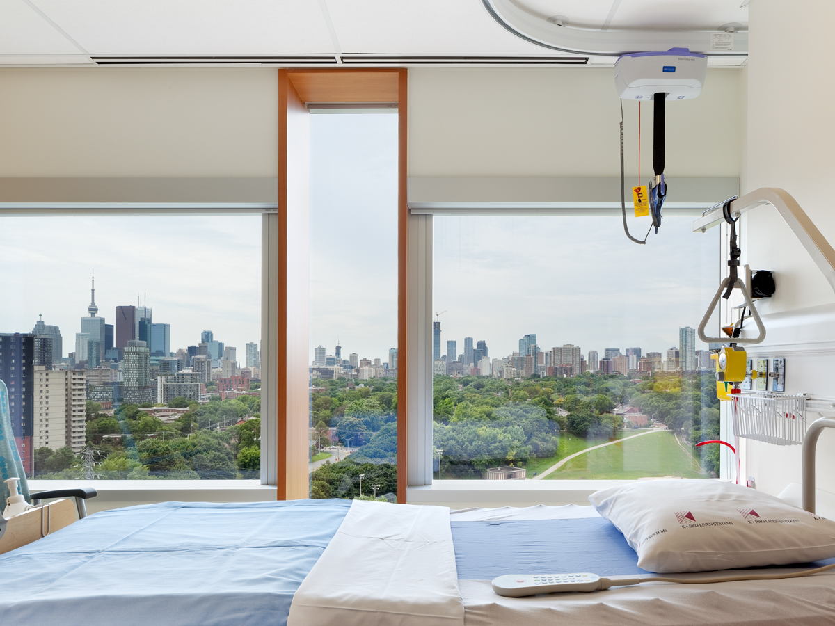 A patient care room in Bridgepoint Active Healthcare, with a view overlooking downtown Toronto
