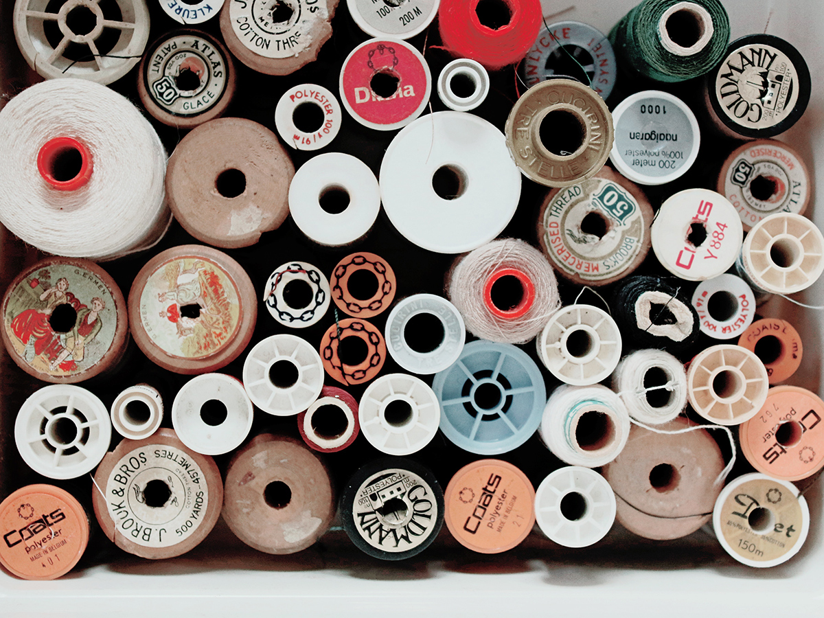 Spools of thread of various size and colour stacked on top of one another
