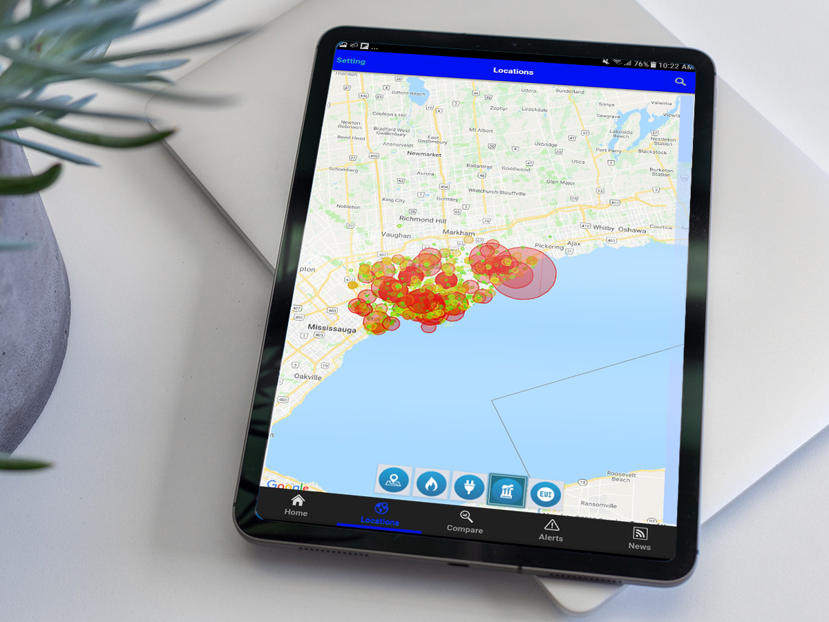 A tablet showcases the Screaming Power app, which tracks energy usage on an overhead map of Toronto