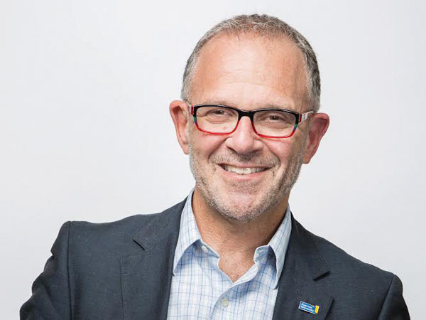 Steven N. Liss, TMU's Vice President, Reseach and Innovation, smiles against a white backdrop.