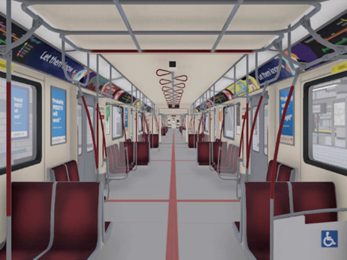 Empty, red seats line a simulated version of a TTC subway car. 