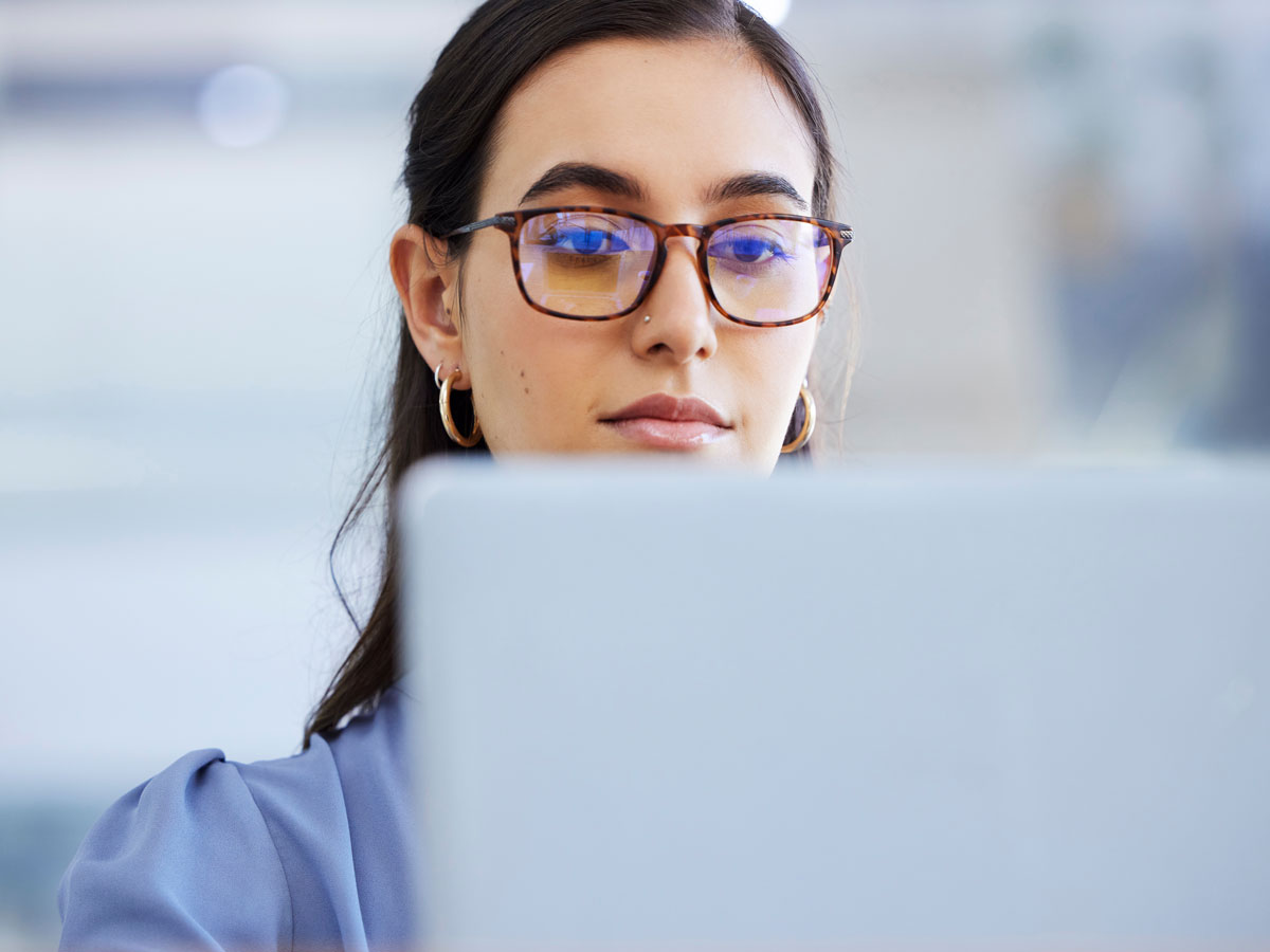 A woman looks at a computer screen.