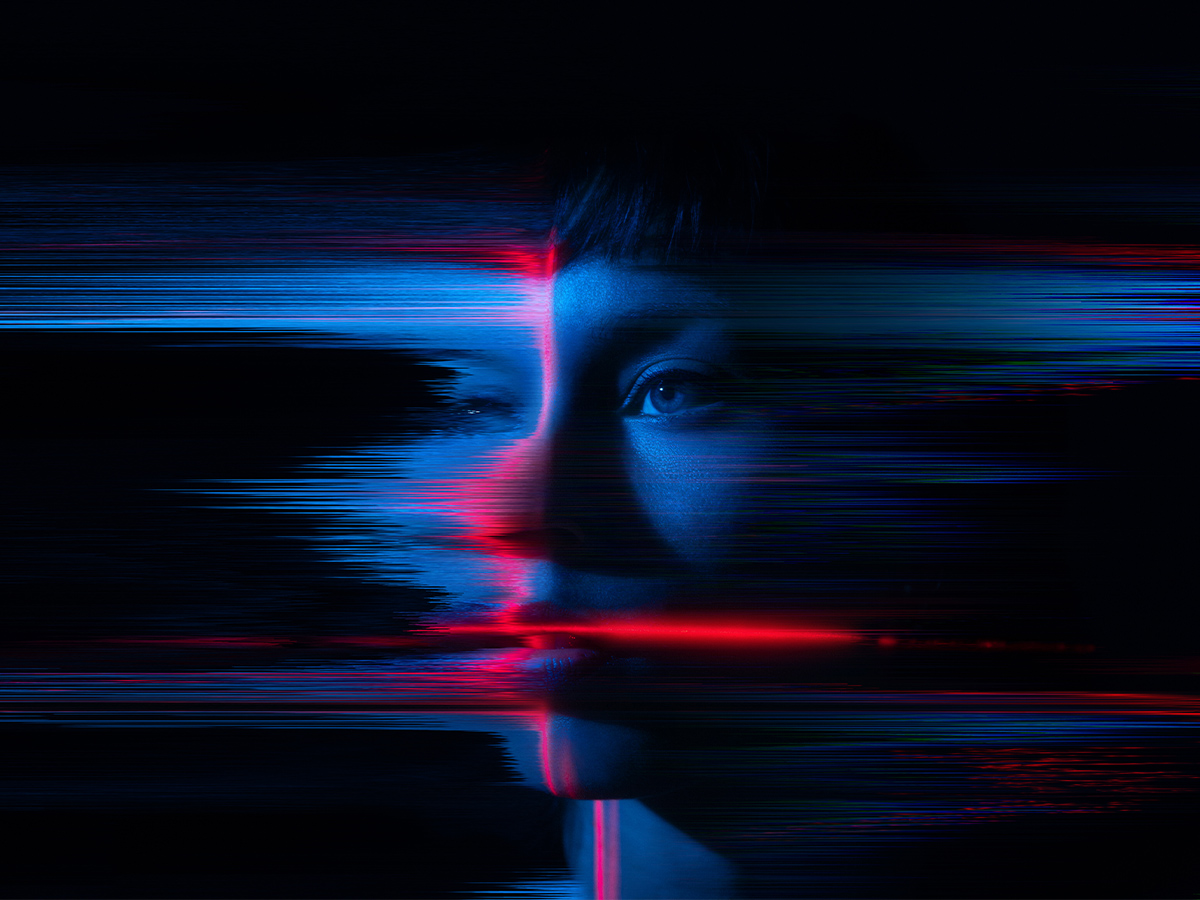 A woman’s face is altered by blue and red digital distortion