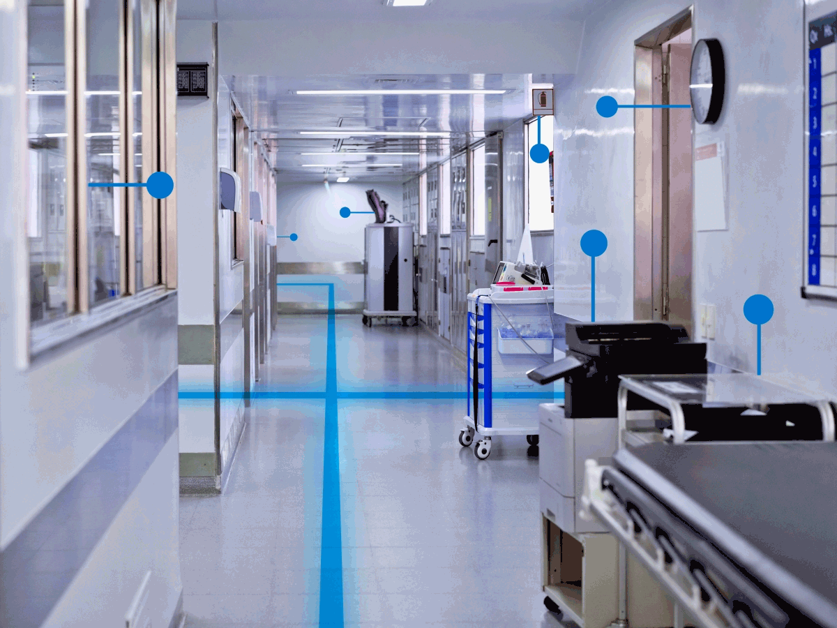 A hospital hallway with an animation of interconnected beacons weaving through the space.