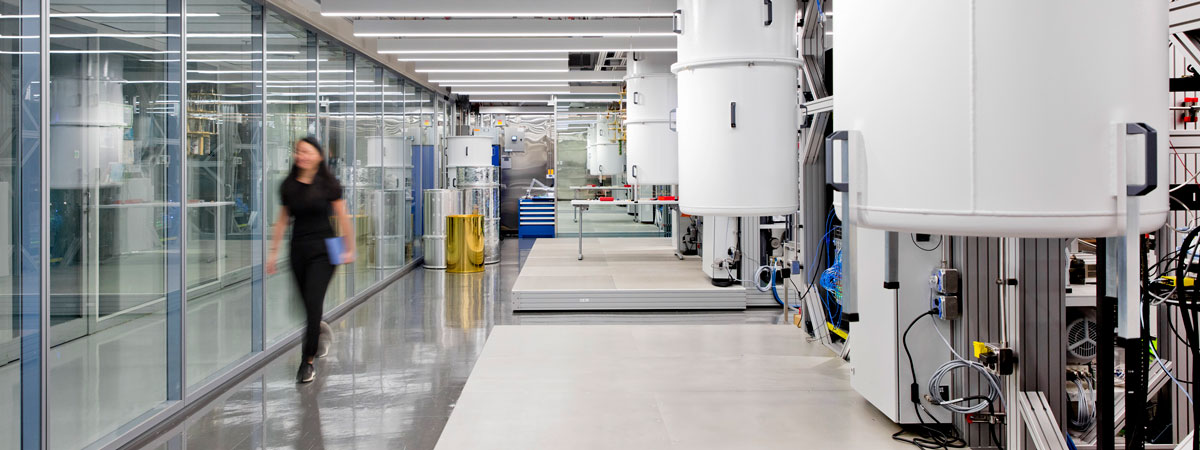 A corridor in an IBM Quantum lab with quantum computers on one side. 