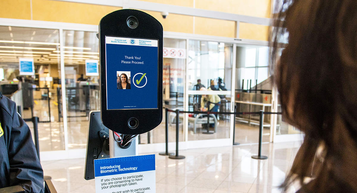 A woman participates in a Biometric Technology ID checking procedure by having her photo taken