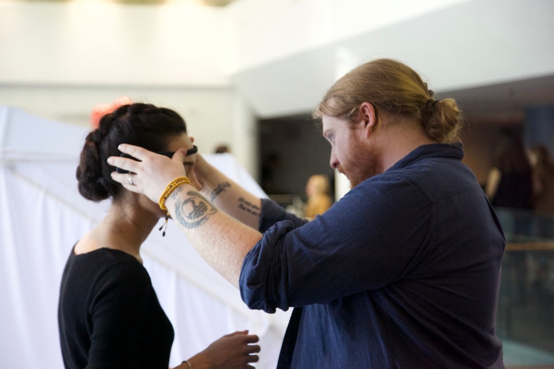 A professor is seen helping a student with a wearable project 