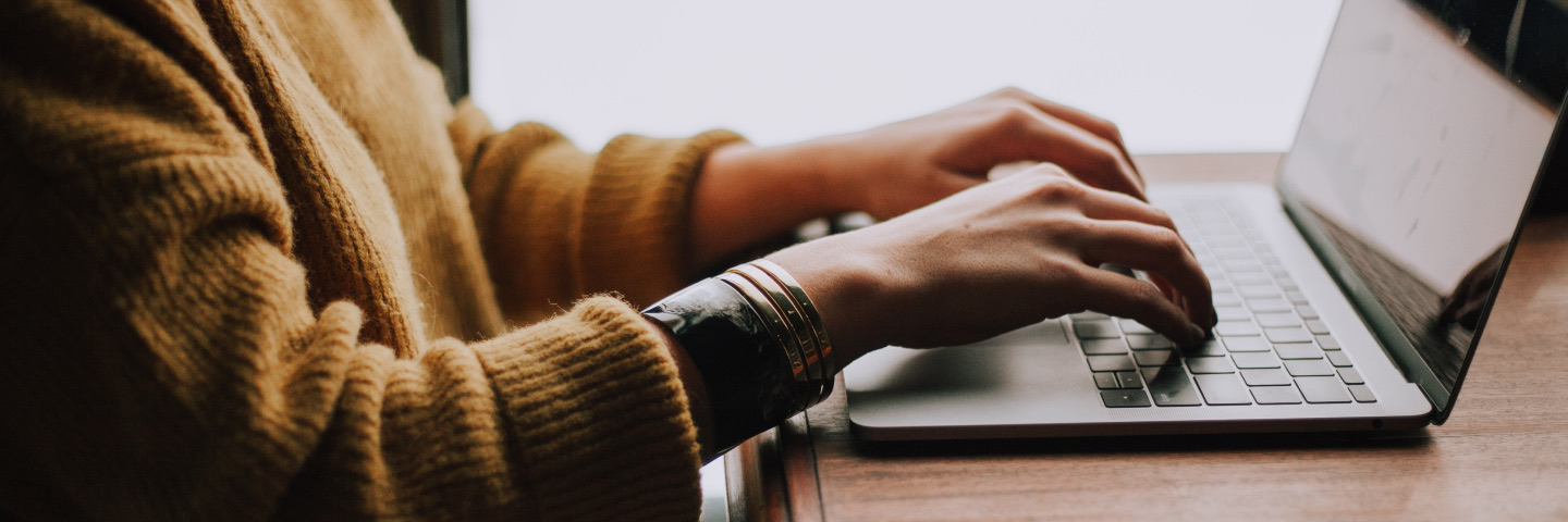 Student typing on a keyboard