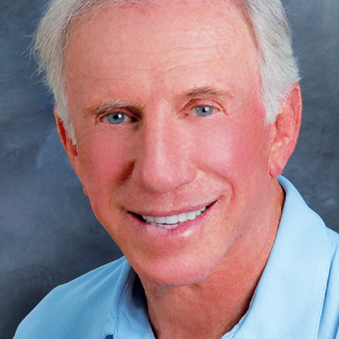 A close-up headshot of Steven Stern. He has white hair, light blue eyes, and is smiling while wearing a light blue collared shirt.