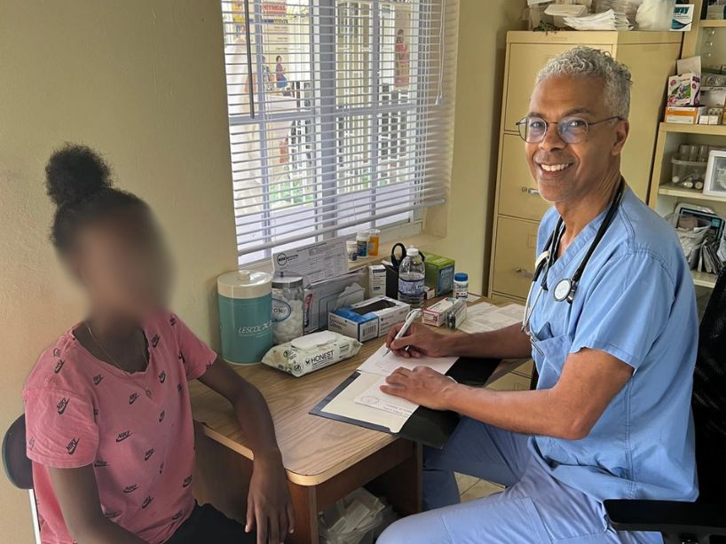 TMU doctor doing intake for a patient in Jamaica