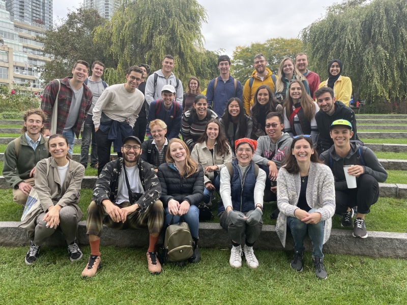 Smiling students pose on garden steps during a field trip