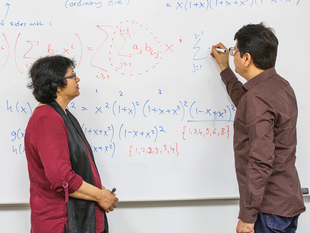 Faculty of Science, Mathematics researchers working on equation.