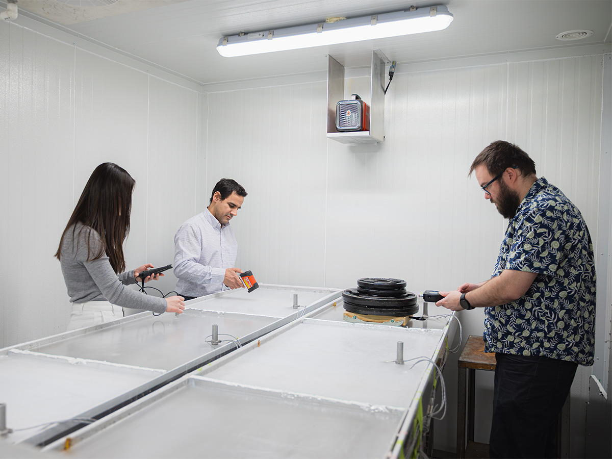 Researchers using tools to test ice in chamber