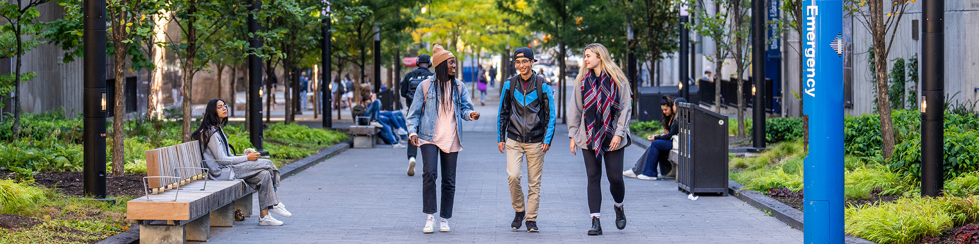 Three students walking in Nelson Mandela Walkway 