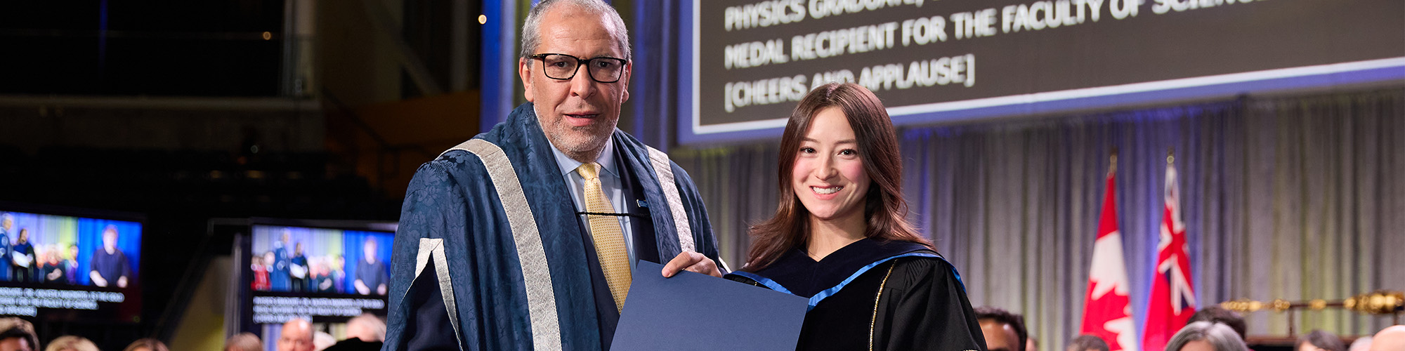 Kalysta Makimoto holding her award at convocation