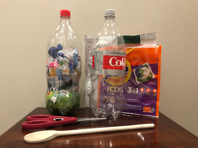 Materials used in rock candy and ecobrick projects: scissors, wooden spoon, plastic bottles.
