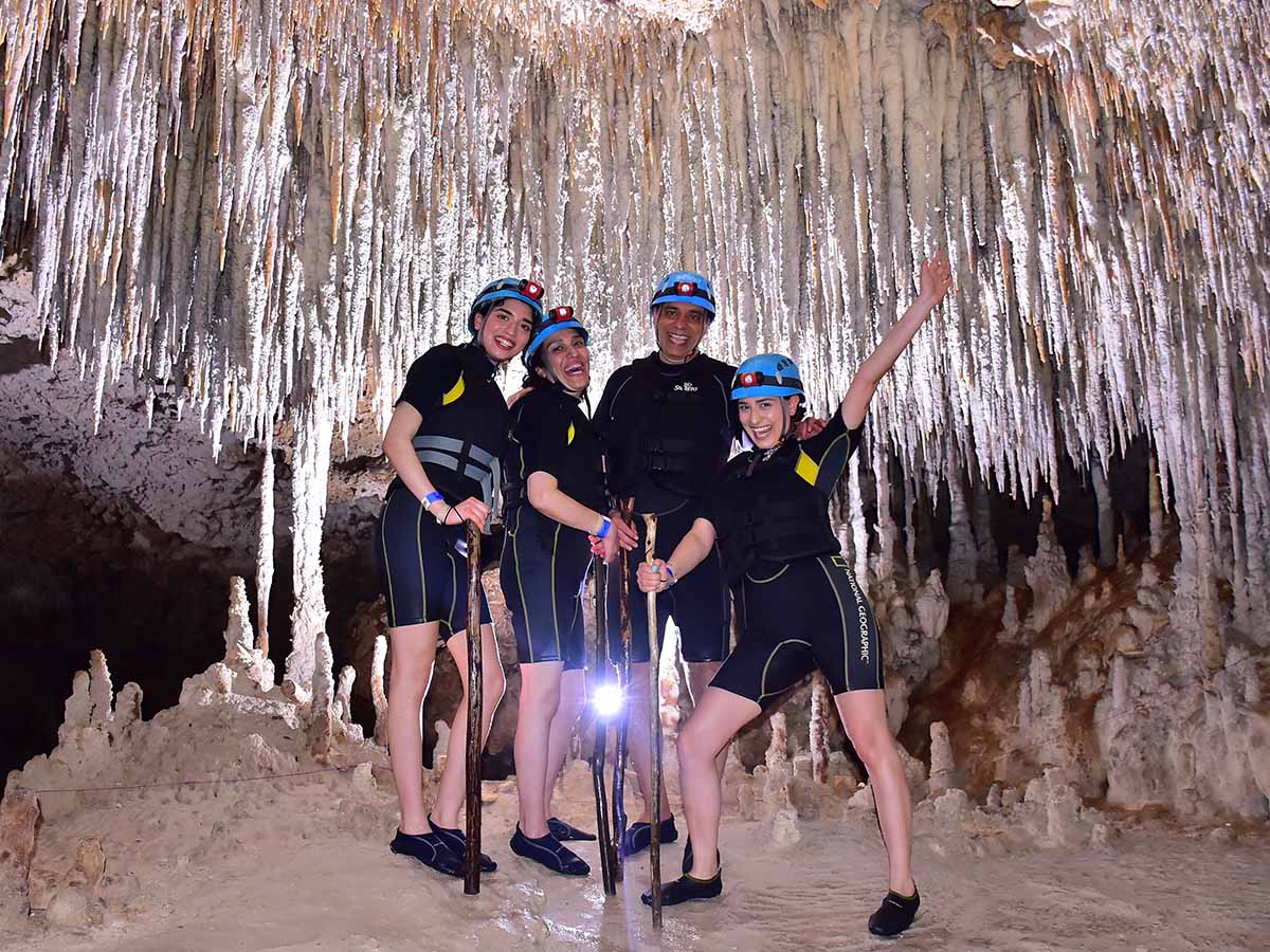Professor Jahan Tavakkoli and family smiling in a cave in Cancun, Mexico