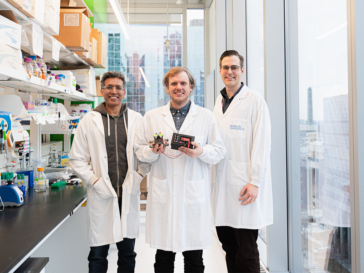 Dr. Gagan Gupta, Thomas Nesmith and Dr. Darius Rackus in the TMU MaRS lab while Thomas holds up the OpenPore.