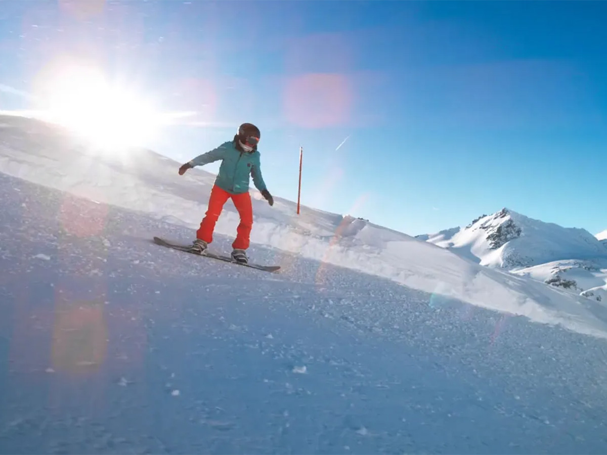 Person snowboarding down a snowy mountain