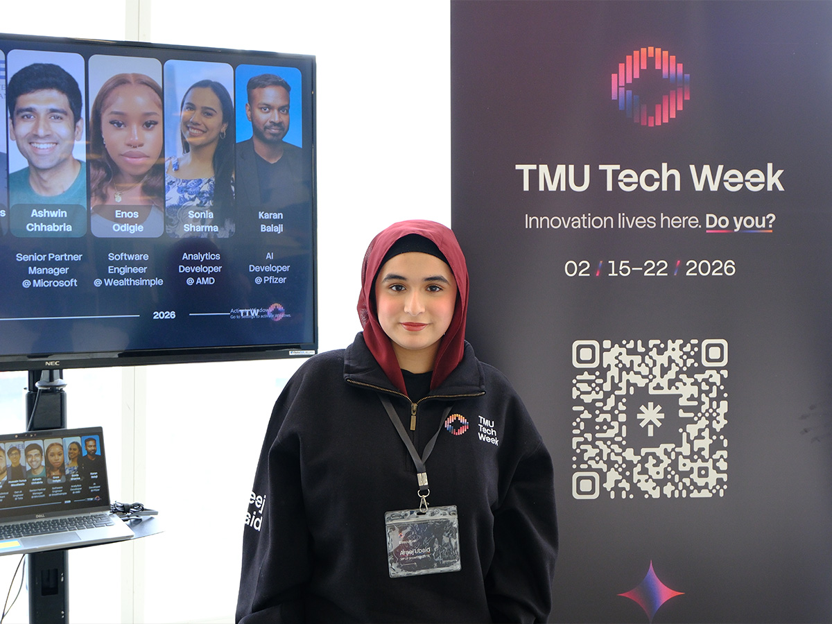 Areej Ubaid in front of the TMU Tech Week sign