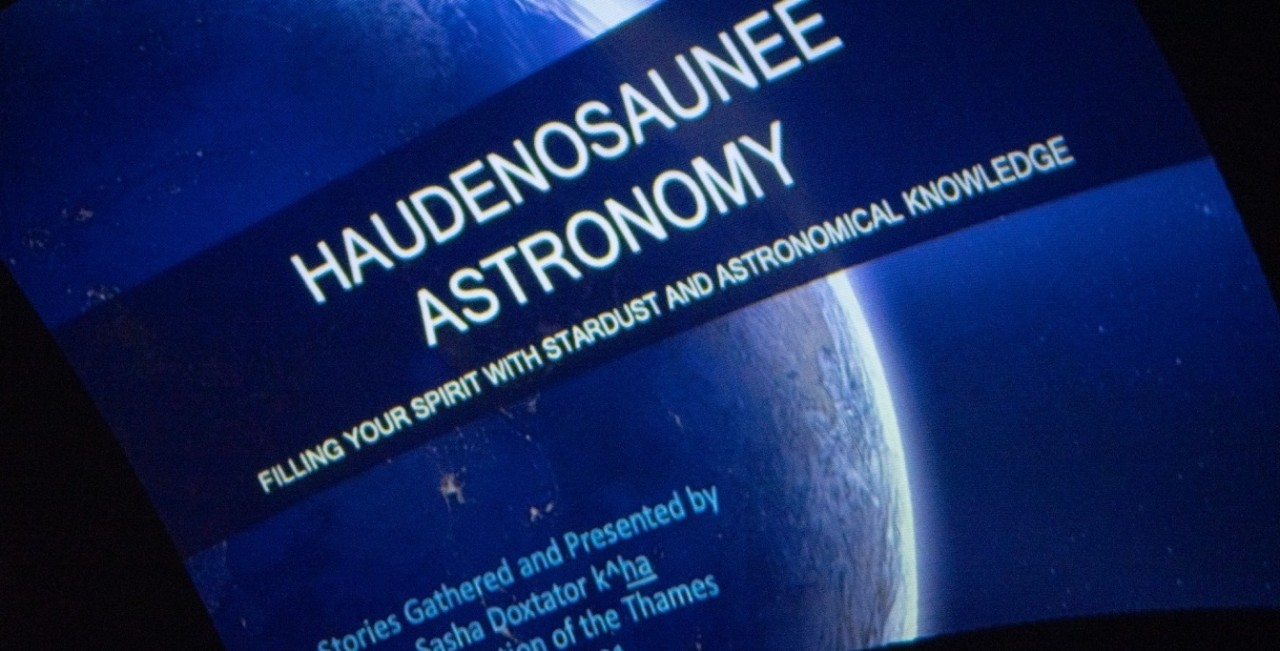The title screen of the Haudenosaunee Astronomy presentation by Samantha Doxtator inside the planetarium.