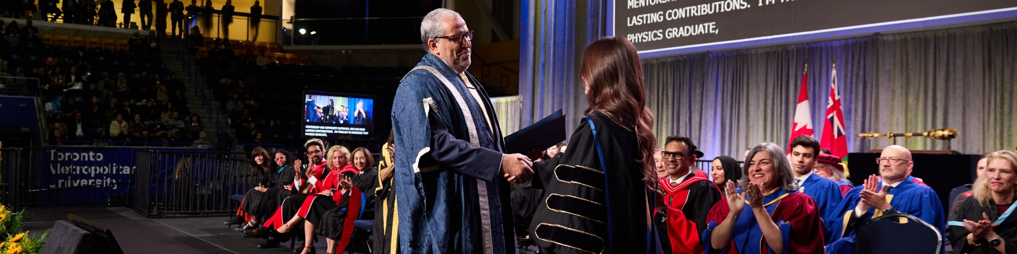 Student receiving award from President Lachemi at convocation