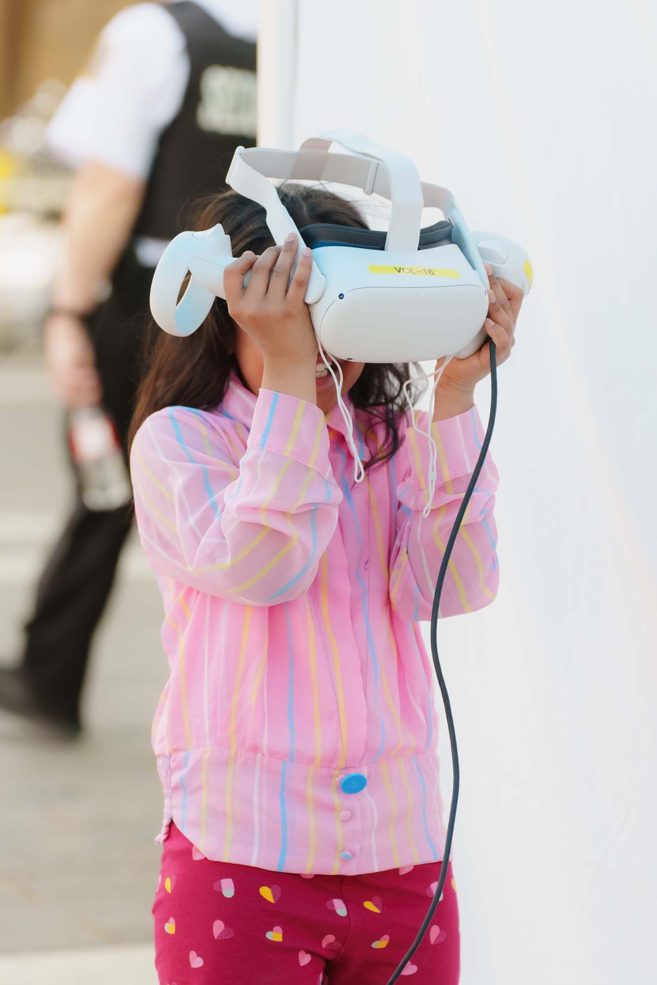 A child excitedly putting on a virtual reality headset.