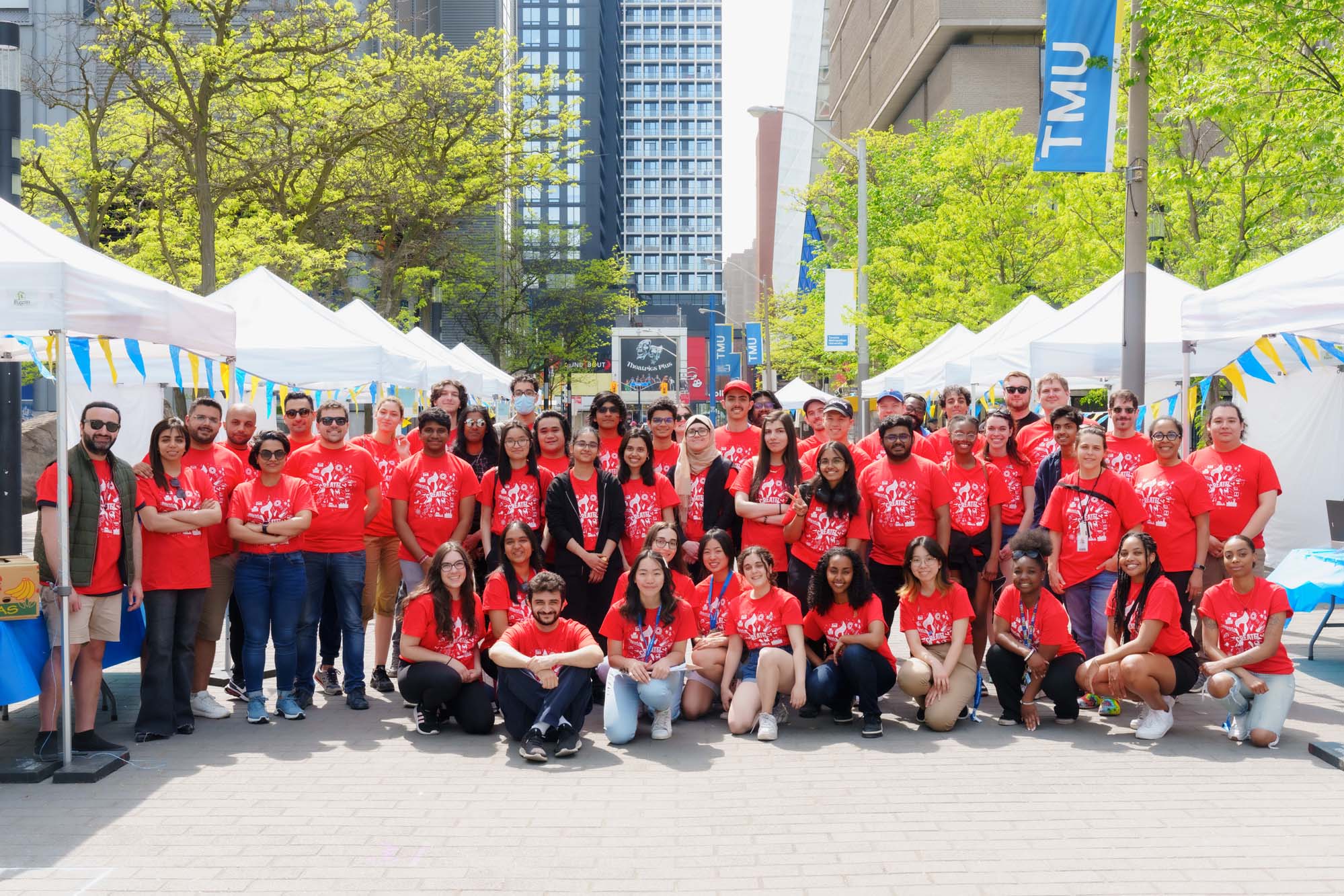 Science Rendezvous volunteers gather together to pose for a group photo.