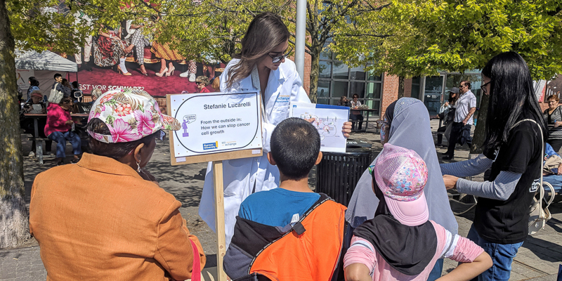 Scientist Stefani Lucarelli talks casually about her research to audience members at Toronto Harbourfront during Word on the Street Festival