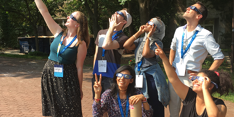 SciXchange volunteers wearing eclipse glasses.